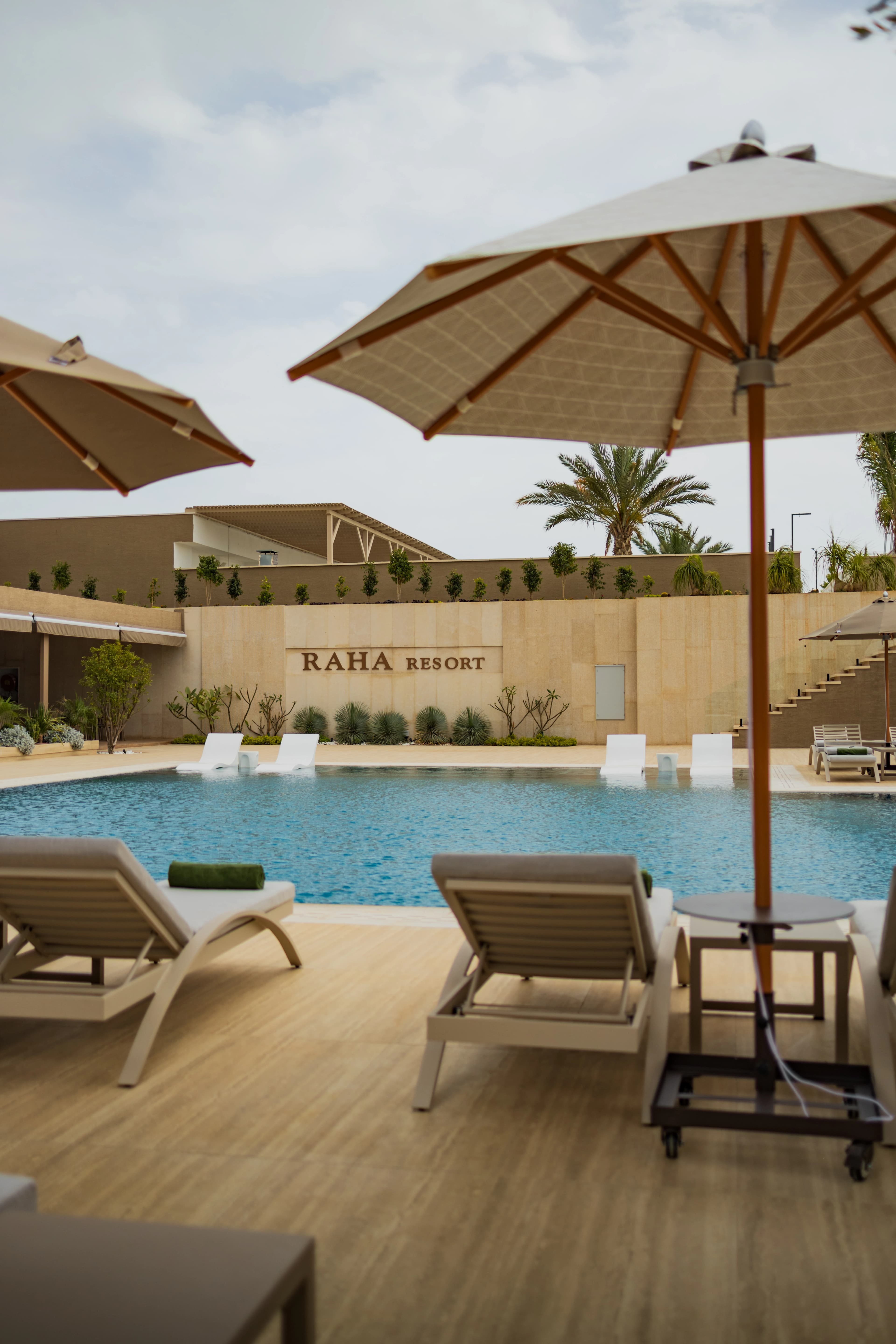 Pool with Raha Resort sign