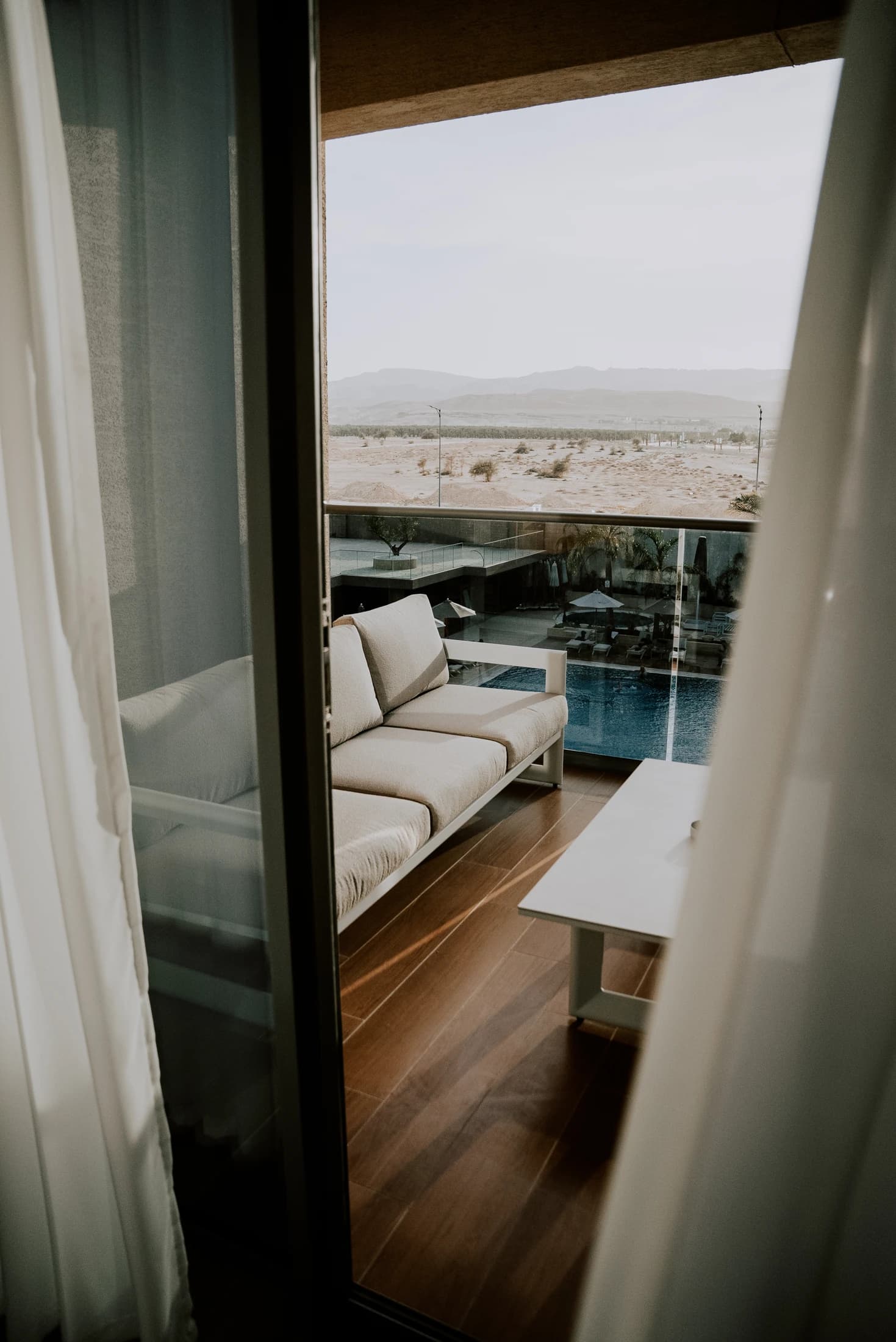 The terrace and pool view from a Raha Resort suite